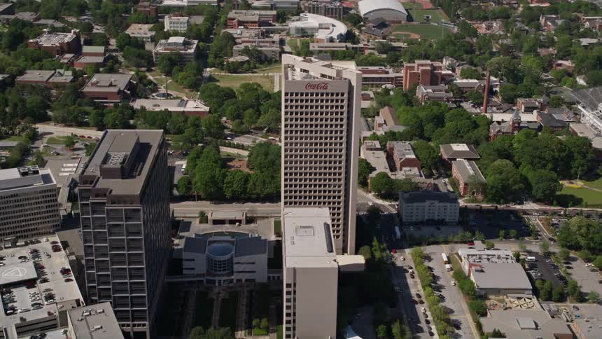 Aerial footage approaches the Coca-Cola Company headquarters in downtown Atlanta during a sunny day in summertime