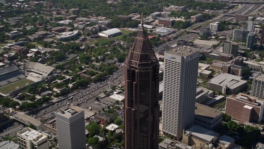 Approaching Bank of America Plaza Midtown Atlantas iconic superstructure captured in stunning aerial footage during a sunny summer day