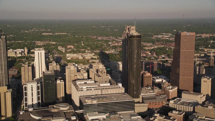 Approaching high-rise hotels and skyscrapers in Downtown Atlanta Georgia during a hazy sunset