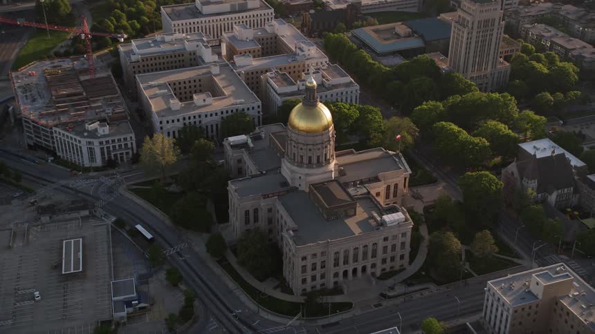 Aerial footage of Georgia State Capitol in Downtown Atlanta approaching and circling around during daytime