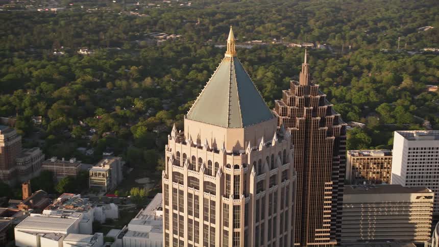 An aerial view at sunset of One Atlantic Center a single high-rise building among the superstructures and skyscrapers in midtown Atlanta Georgia