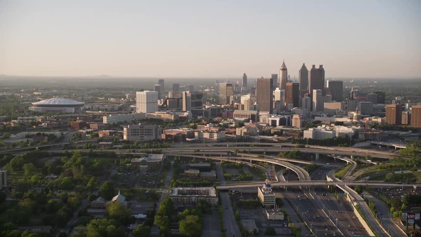 Approaching Downtown Atlanta Georgias hazy skyline during sunset