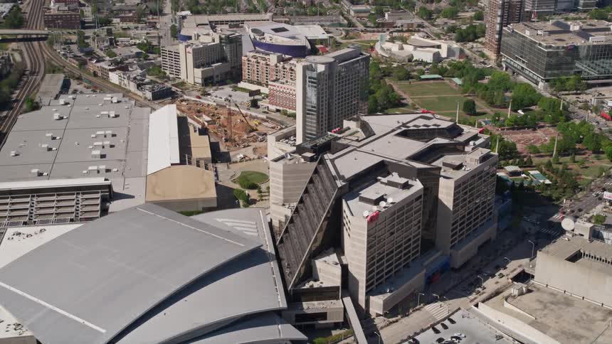 Aerial footage flying over Philips Arena and CNN Center in downtown Atlanta Georgia on a sunny day