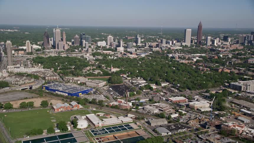 An aerial view of Midtown and Downtown Atlanta Georgia showcasing towering skyscrapers and bustling city life during the daytime