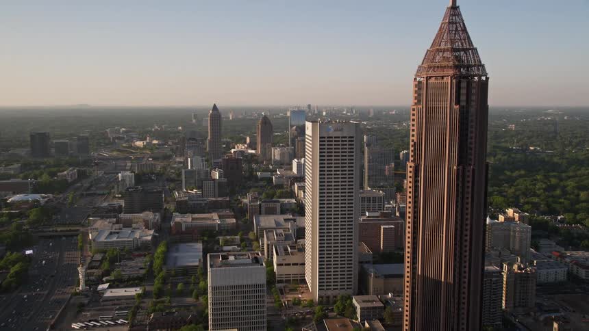 A stunning aerial view of Bank of America Plaza and other towering skyscrapers in Midtown Atlanta Georgia during a hazy evening