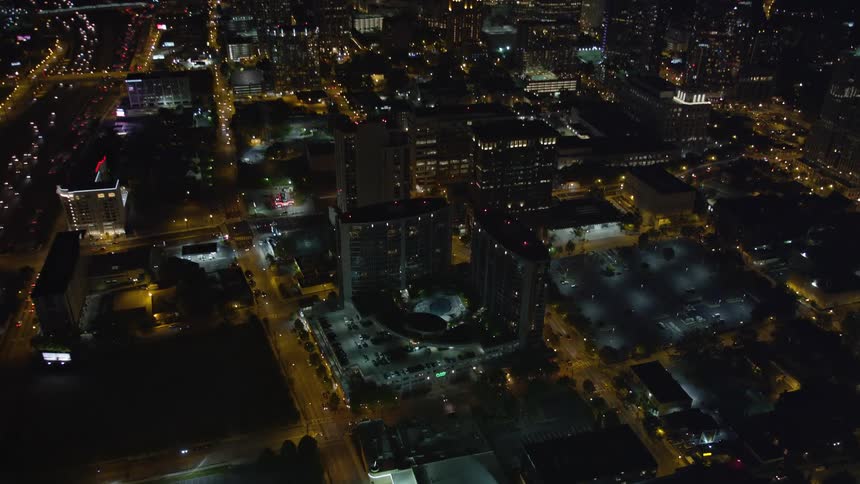Aerial footage of a nighttime view of a condominium complex in Midtown Atlanta Georgia shot during the summer