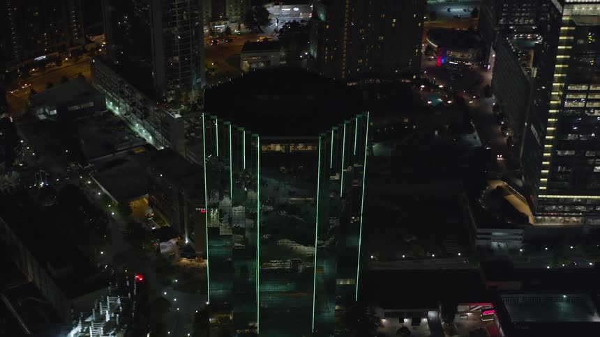 Aerial view of towering skyscrapers and buildings lighting up the city at night in Buckhead Georgia