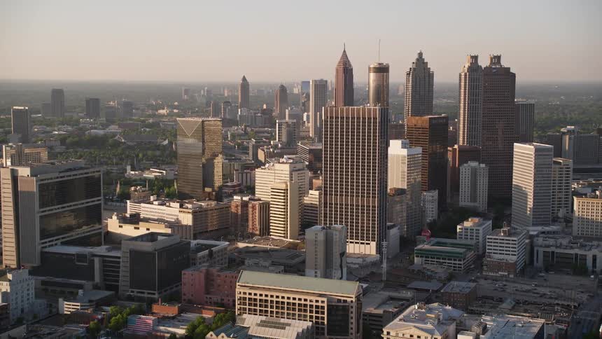 Approaching the towering skyscrapers of downtown Atlanta during hazy sunset