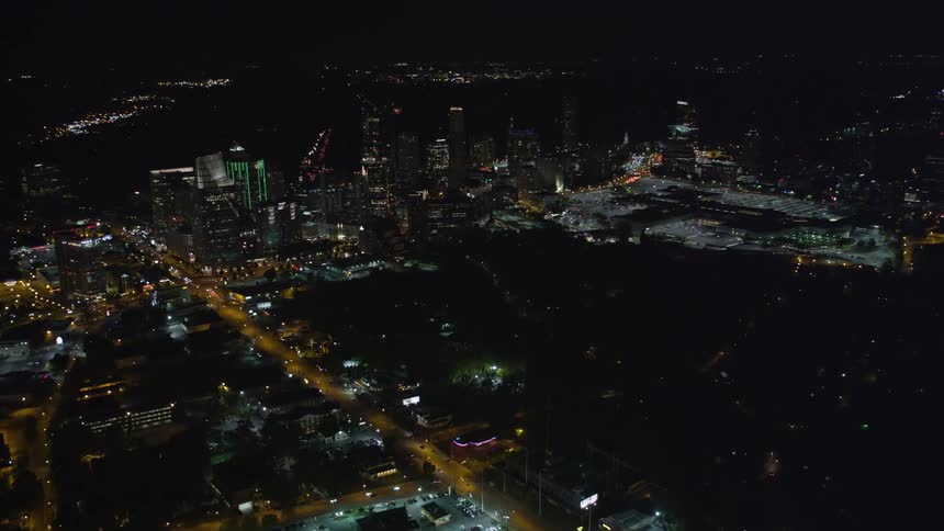 A breathtaking aerial view of Buckheads high rise buildings and Piedmont Road during a clear summer night in Georgia