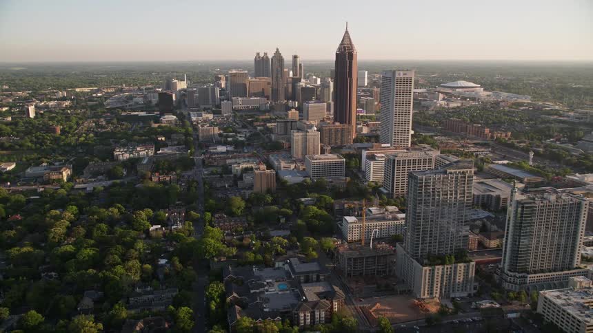 An aerial view of Midtown Atlanta approaching Downtown skyscrapers during the day