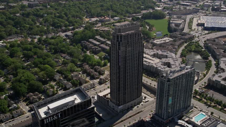 A stunning aerial footage showcasing The Atlantic skyscraper in Atlanta Georgia as the drone orbits around this magnificent high-rise tower amidst the vibrant metropolis