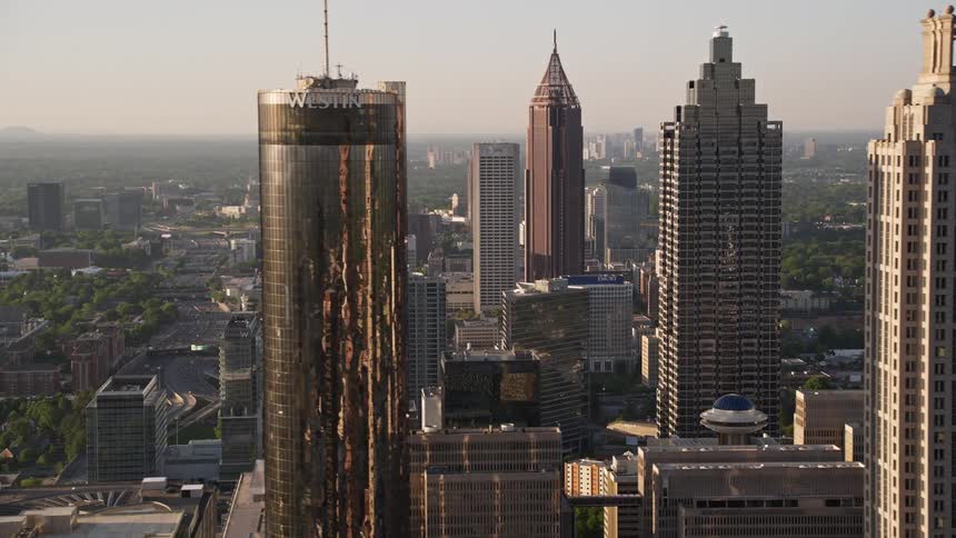 A breathtaking sunset aerial footage of Downtown Atlanta Georgia revealing a row of skyscrapers including the 191 Peachtree Tower Bank of America Plaza and Westin Peachtree Plaza Hotel