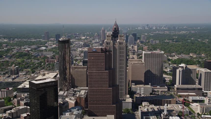 Approaching and flying over the State Capitol and downtown Atlantas skyscrapers during a sunny day