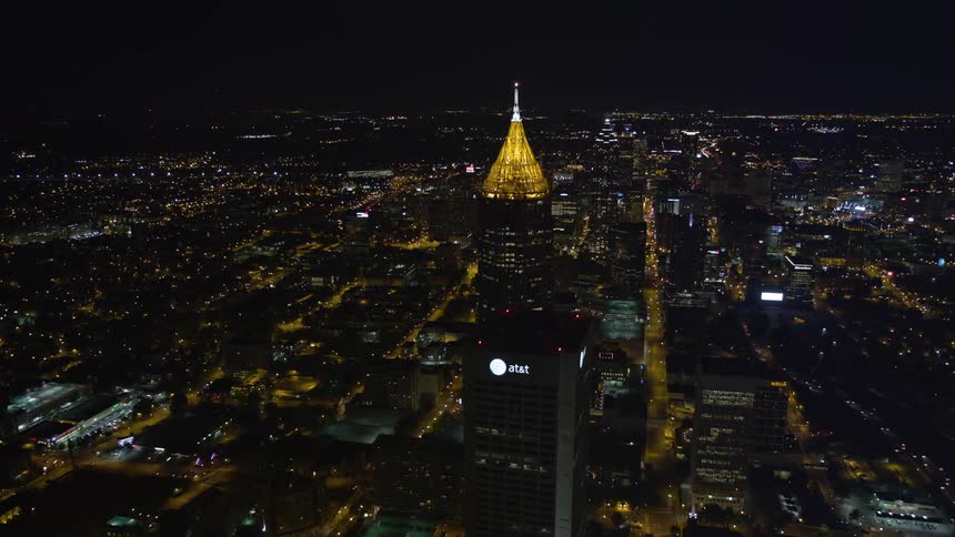 Aerial footage flying towards Bank of America Plaza towards the Atlanta skyline at night