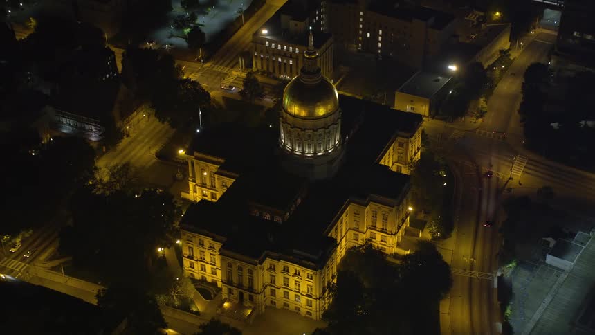 Approaching and tilting down on Georgia State Capitol in Downtown Atlanta during a clear night
