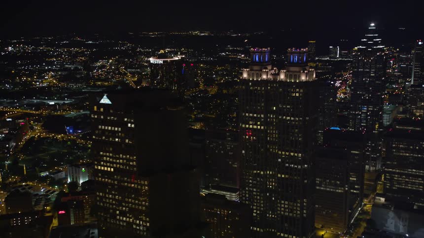 An incredible aerial footage of Downtown Atlanta at night with orbiting and flybys of tall skyscrapers lit up against the clear skies of Summer