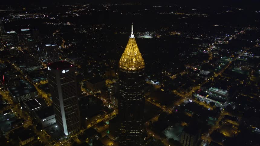 A stunning aerial shot at night of the Bank of America Plaza in Midtown Atlanta revealed after tilting down from the black sky