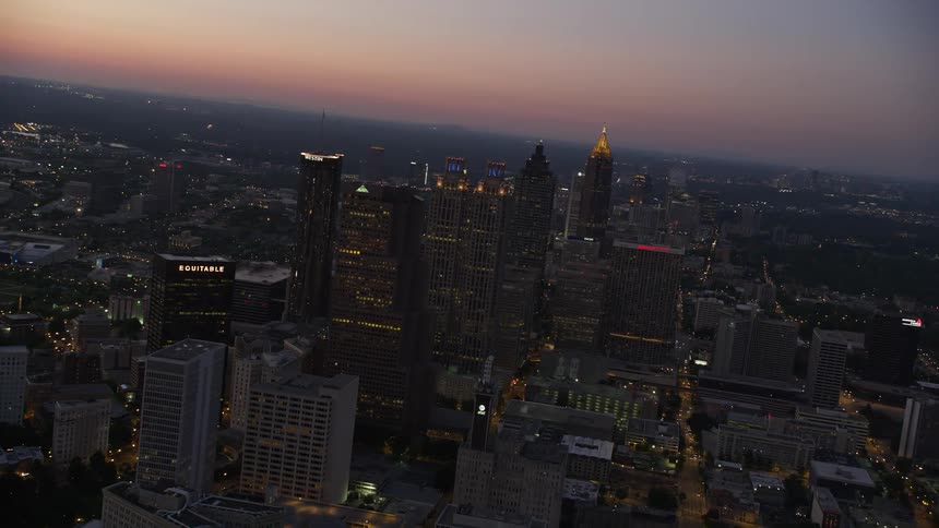 Aerial footage of downtown Atlantas skyscrapers at sunset flying toward Midtown with a wide-angle view