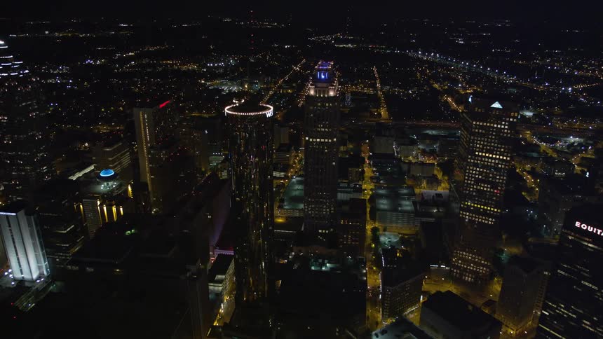 Approaching 191 Peachtree and tilting to birds eye view of Downtown Atlantas skyscrapers at night