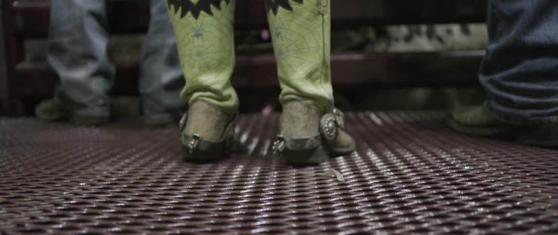 A closeup of green cowboy boots