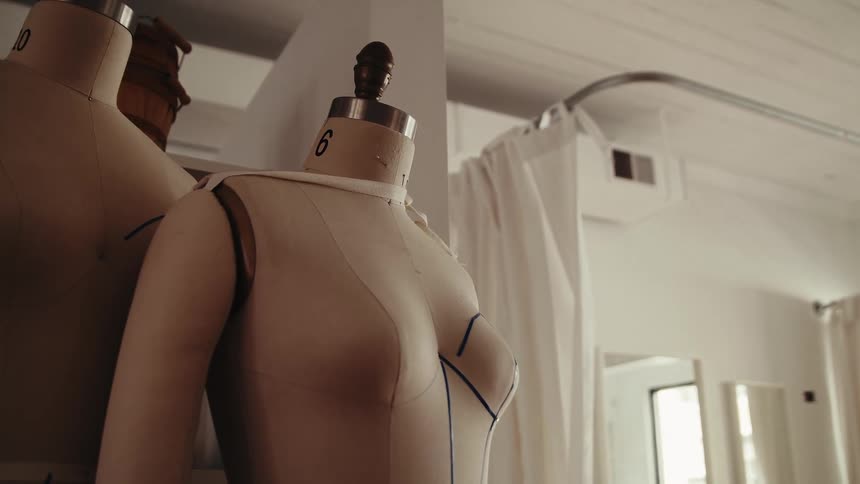 Mannequins are in the corner of the room