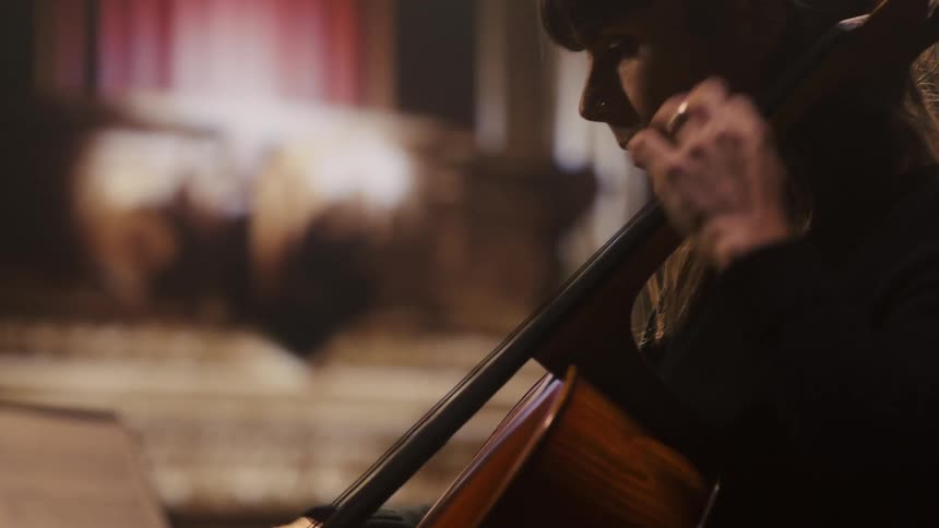 A woman is playing the cello