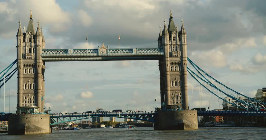 View of Tower Bridge from boat moving down the River Thames