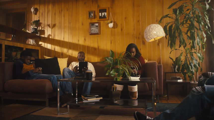 A family sitting around in a room together