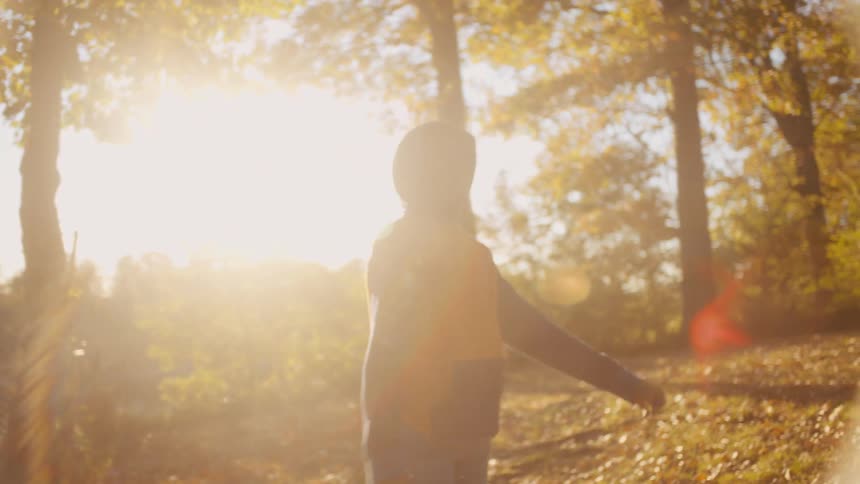 A girl tosses a football to her brother