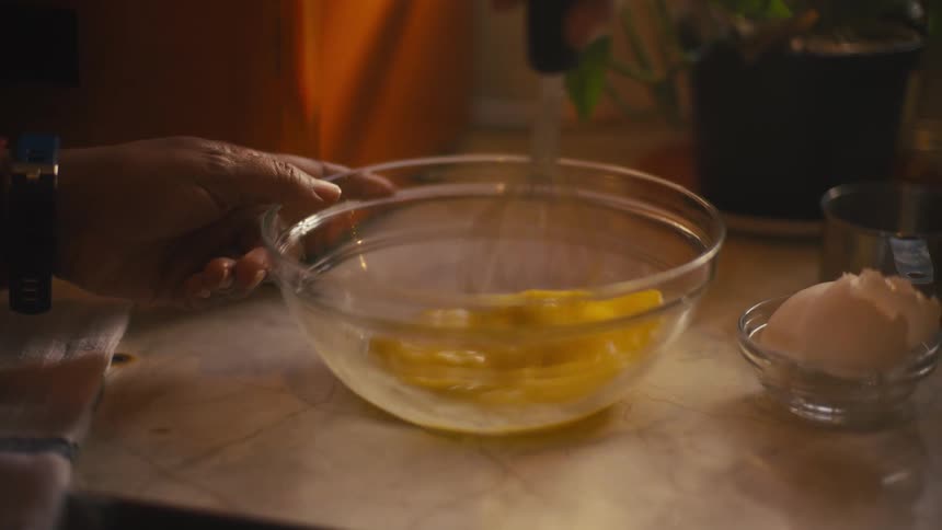 A person is whisking eggs in a bowl