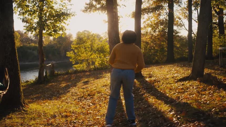 A family playing football outside on a sunny autumn day
