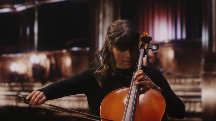 A female musician playing a cello