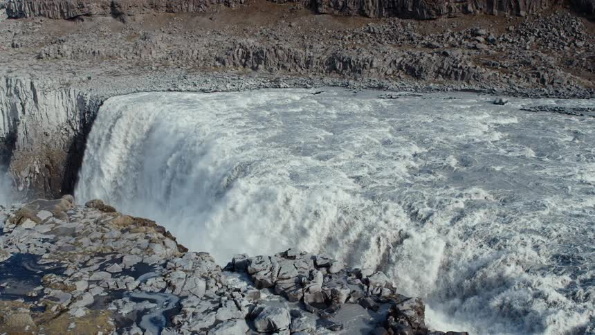 Waterfall cascades over a rocky edge