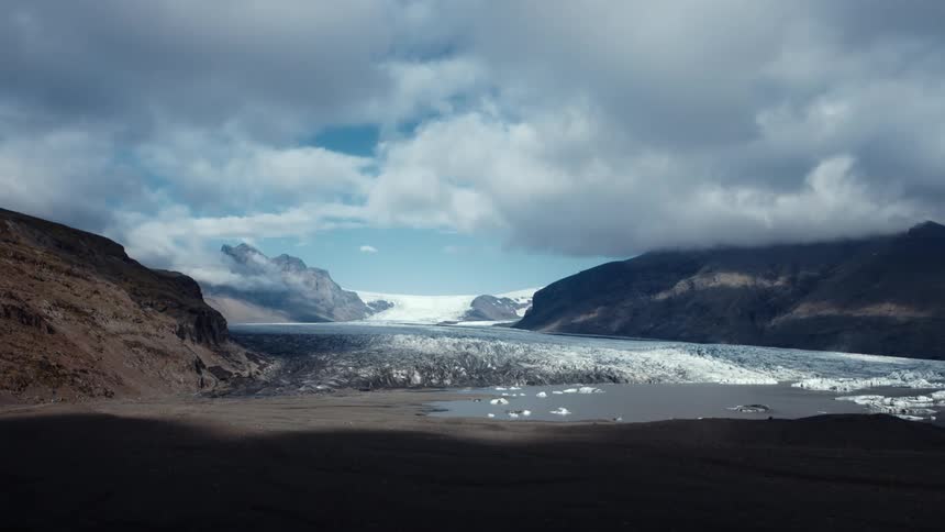 Clouds floating above a snowy mountain landscape in the wilderness
