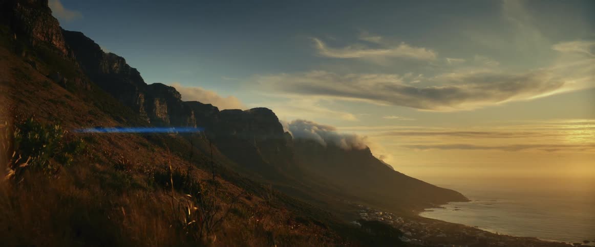 Landscape of coast seen from the slope of mountain at sunset