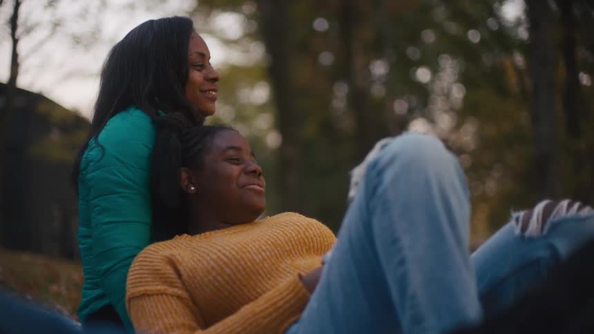 Two women sitting outdoors