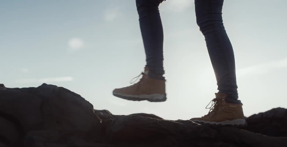 A person is hiking on some rocks