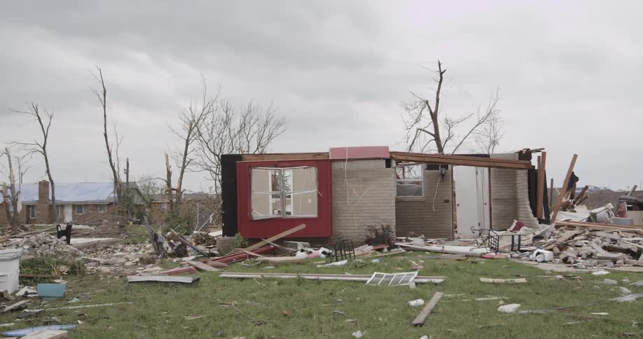 Storm debris lying around a home that was destroyed