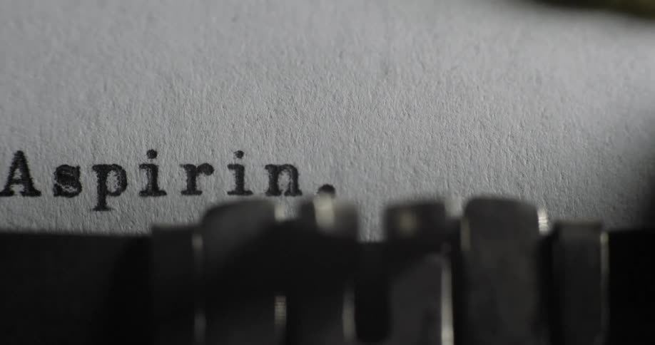 A typewriter strikes against paper