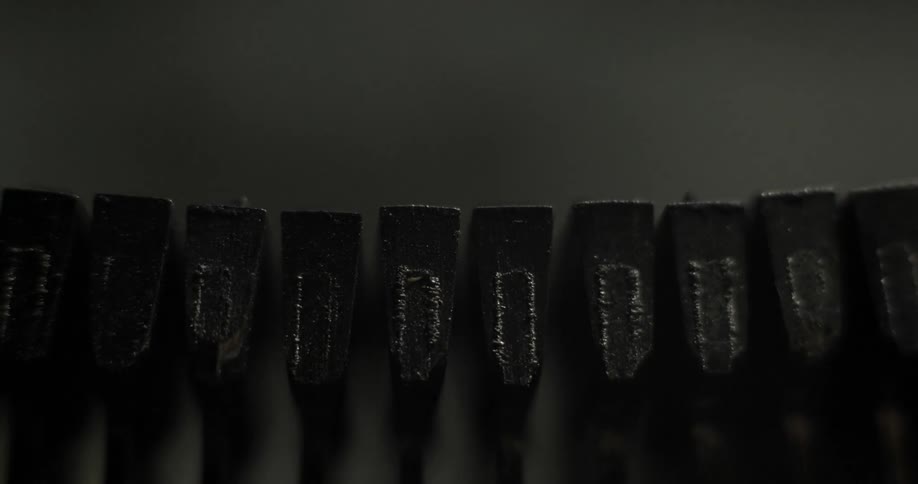 Typewriter strikers slam against paper