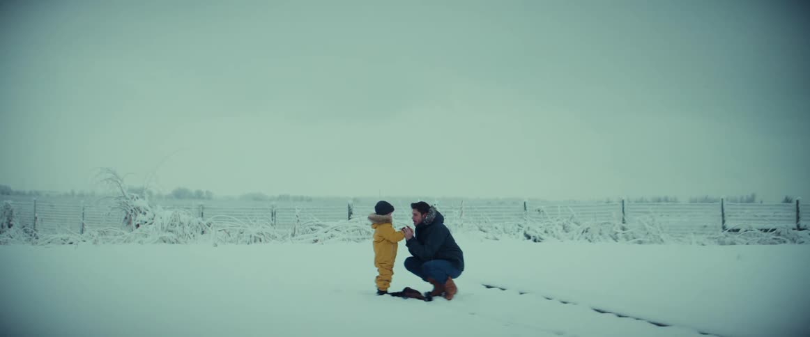 Father and young child rubbing their hands to warm up