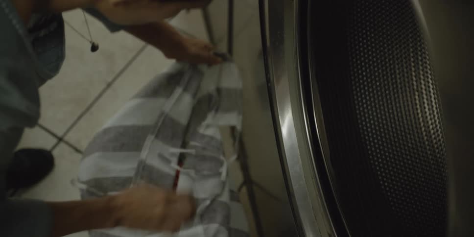 A person is doing laundry indoors