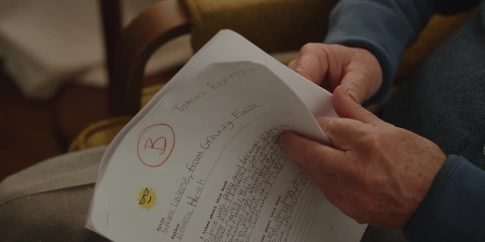 A man is examining a graded test paper