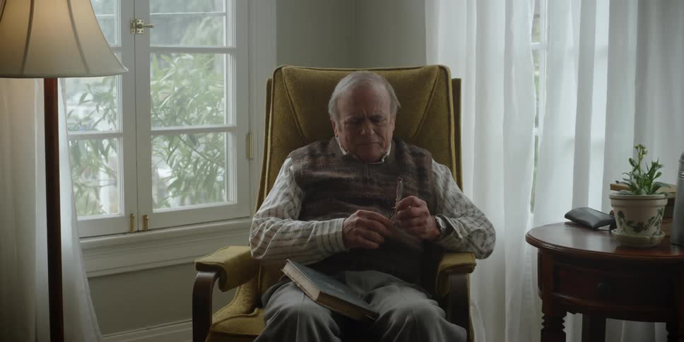 A man reads a book at home after a boy leaves