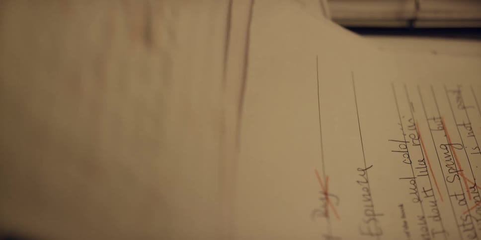 Woman puts schoolwork with a d grade on top of the pile