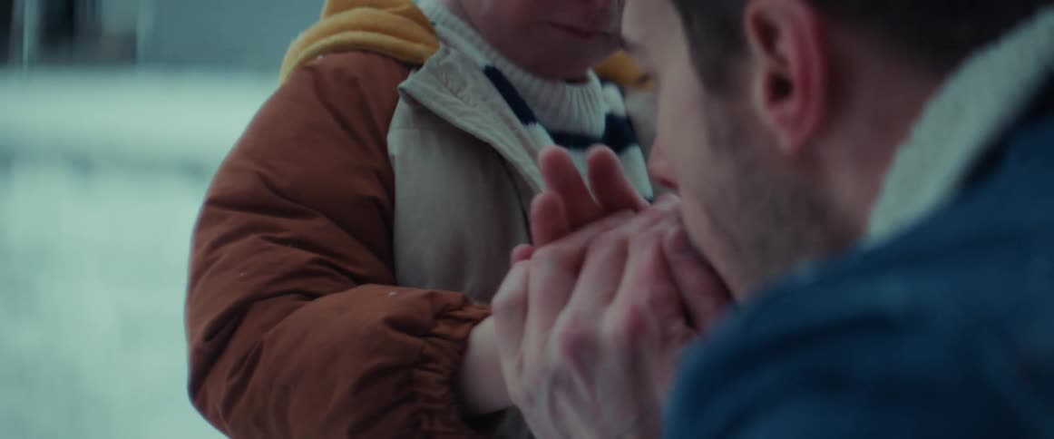 A father is warming his sons hands