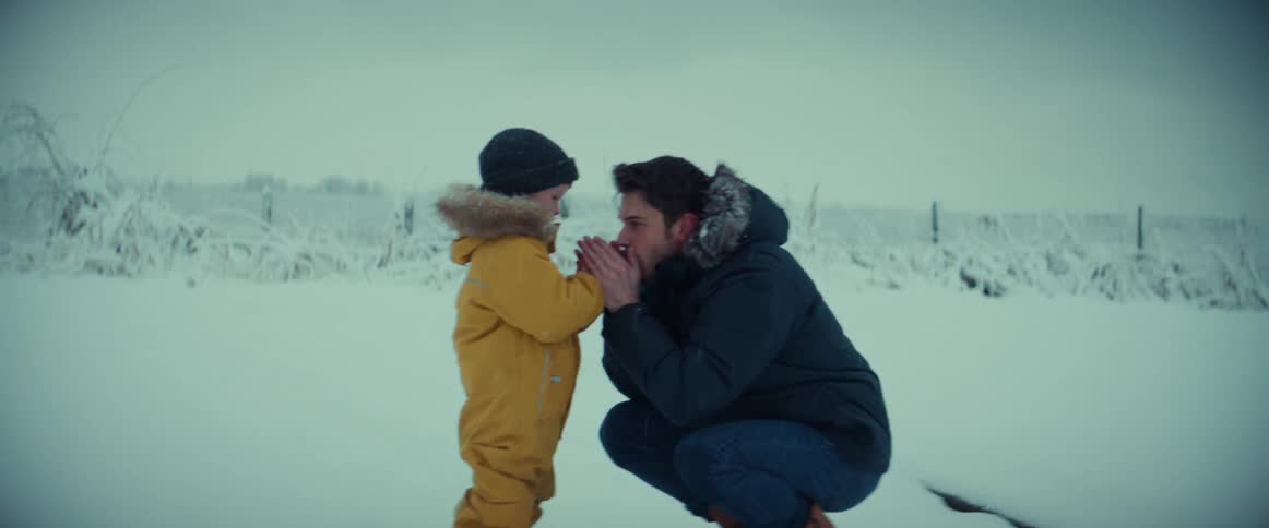 Father and son are hanging outside in the snow