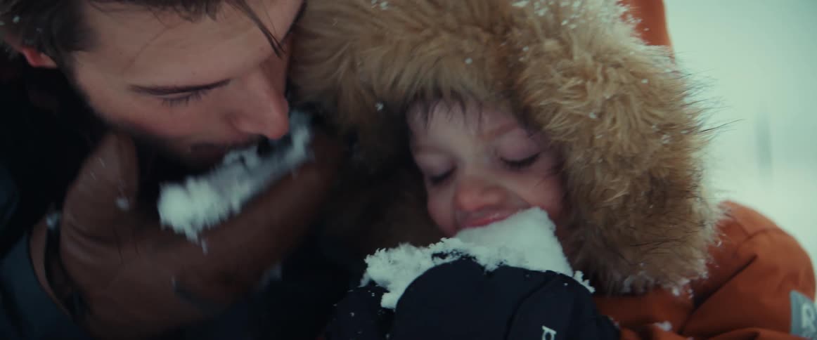 Father and son eat snow