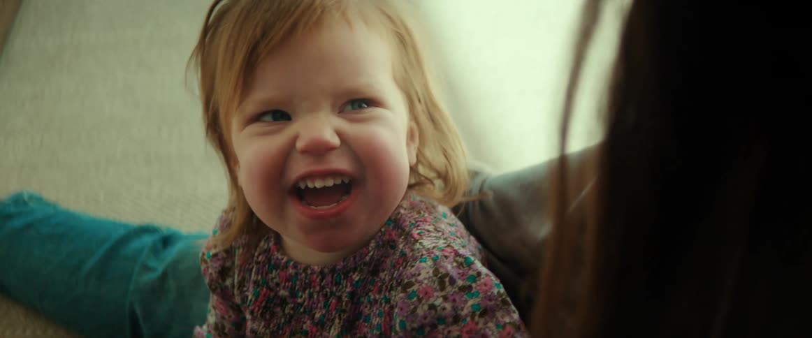 Mother and daughter are sitting down and being playful with each other