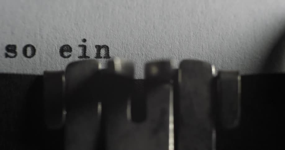 Close up of words being typed onto paper on a mechanical typewriter